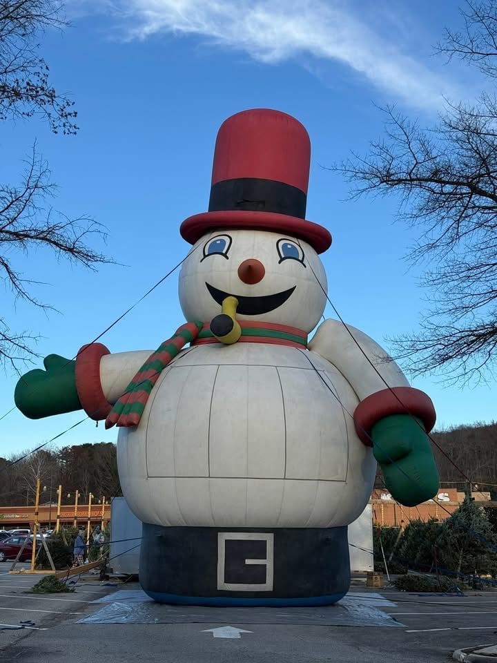 Frosty, the 30-foot inflatable snowman in his red top hat and striped scarf, towering over the Roanoke lot with the shopping center behind