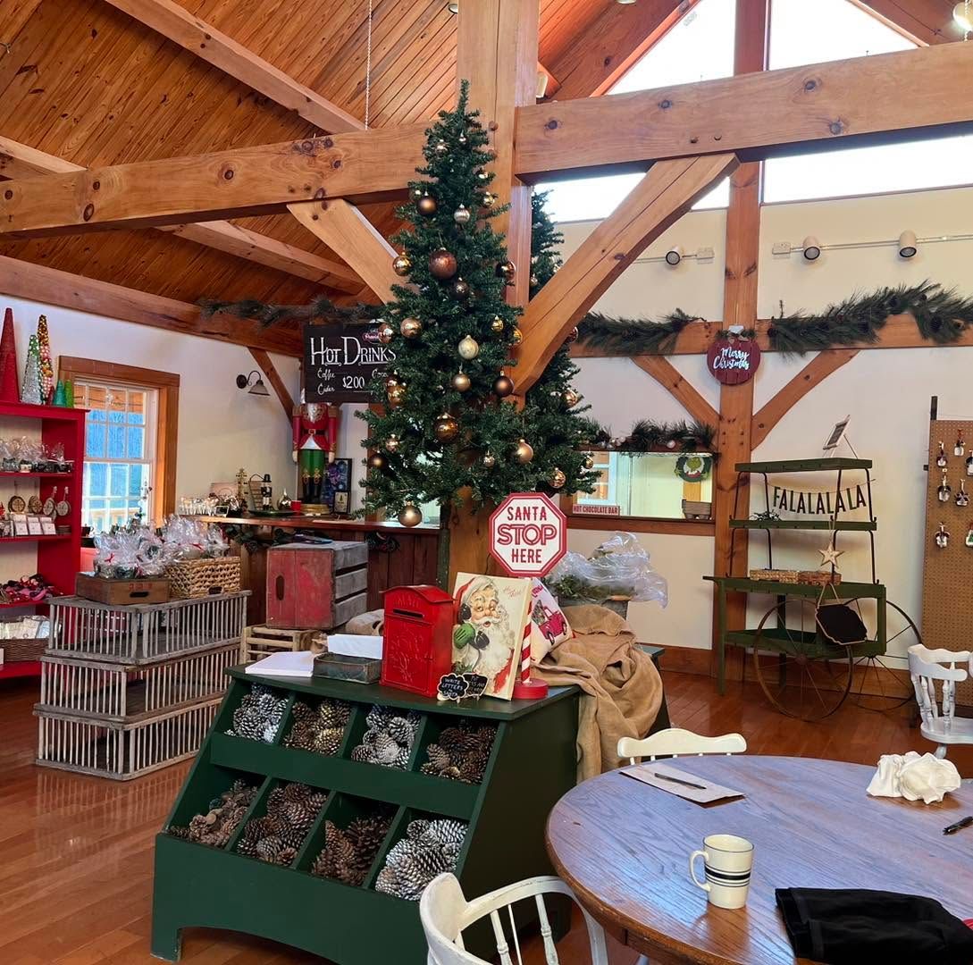 Inside the store: timber beams, a decorated tree, bins of ornaments and a “Santa stop here” sign